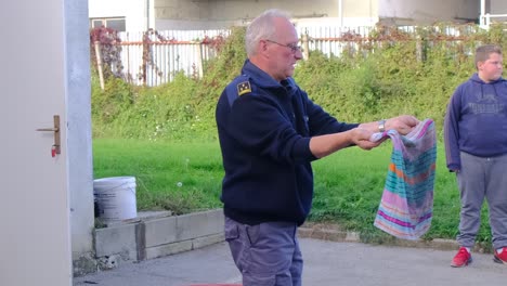 Firefighter-demonstrates-extinguishing-a-kitchen-fire-with-wet-blanket