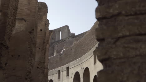 Reveal-of-Colosseum-Walls-and-Arches-in-Rome,-Italy