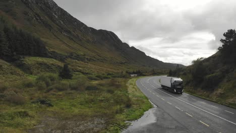 Aerial-footage-of-truck-approaching-on-the-corner-on-a-mountain-pass