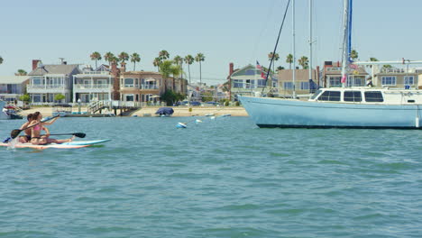 Slow-motion-Stand-Up-Paddle-Boarders-taking-a-Break-on-a-Sunny-Day-at-the-Harbor