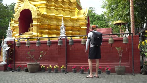 Ringing-a-bell-at-a-temple-in-Chiang-Mai,-Thailand