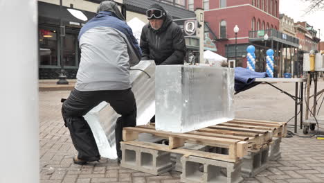 Escultores-De-Hielo-Cargando-Bloques-De-Hielo-En-Una-Plataforma-Rodante-Con-Pinzas-Para-Hielo