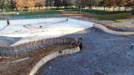 AERIAL-Labourers-Working-On-Public-Swimming-Pool-Under-Construction