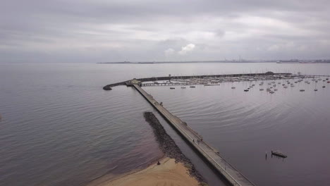 Drone-aerial-view-of-St-Kilda-Pier-Kiosk,-overcast-grey-day-time,-Australia-Melbourne