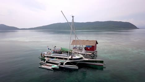 Disfrute-De-Un-Tour-En-Barco-Por-El-Archipiélago-De-Raja-Ampat,-Indonesia,-Que-Lleva-A-Los-Huéspedes-A-Un-Tour-De-Esnórquel,-Toma-De-Pedestal-Aéreo