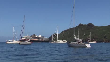 Cruise-ship,-small-yachts-and-sailboats-in-Taiohae-bay,-Nuku-Hiva,-Marquesas-Islands,-French-Polynesia