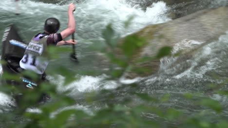 A-competitor-rowing-through-obstacles-during-a-canoe-race