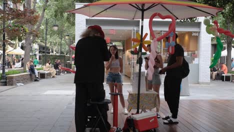 Group-of-teens-watching-balloon-maker