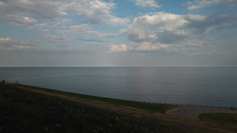 A-motion-time-lapse-overlooking-Lake-Ontario,-showing-people-gathering,-seen-from-the-R