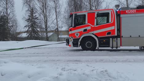 Crashed-car-towed-on-snowy-street-from-accident-site-by-rescue-truck