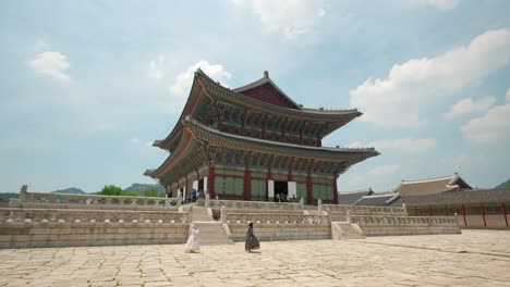 Traveler-girls-take-pictures-wearing-hanbok-dresses-near-Gyeongbokgung-Palace-on-a-summer-cloudy-day