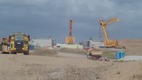 Heavy-Dumpster-Vehicles-Taking-Soil-Away-for-Developing-a-Motorway-or-Highway-in-England---Static-Wide-Shot