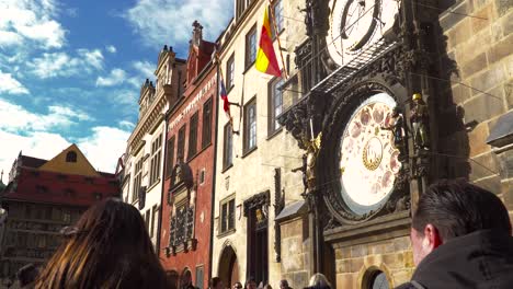 Tourists-looking-at-Prague-clock-tower-on-sunny-day