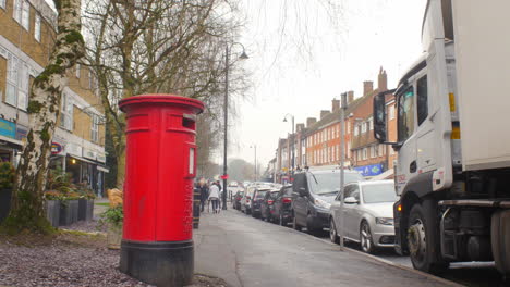 Iconic-English-mailbox-in-a-shopping-street-of-a-middle-class-London-suburban-town