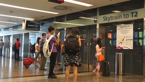 Changi,-Singapore,-Circa-–-Busy-travelers-rush-about-their-day-at-Singapore-airport