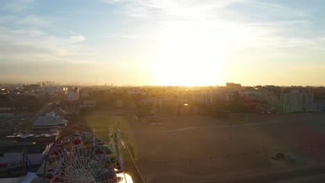 Aerial-pedestal-of-ferris-wheel-in-Santa-Monica-during-sunrise