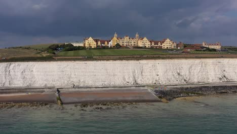 Wide-aerial-profile-view-of-Roedean-School,-situated-on-the-Chalk-cliffs-near-Brighton,-UK