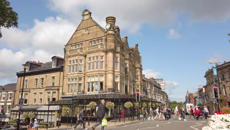 Pedestrians-Crossing-the-Road-in-Front-of-Bettys-Tea-Room-with-Traffic-Waiting-at-Lights