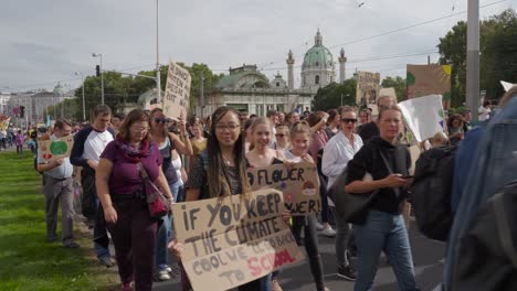 Protestors-walking-through-street-of-Vienna-with-backdrop-of-St