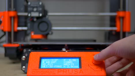 Hand-Pausing-3D-Printer-During-Print