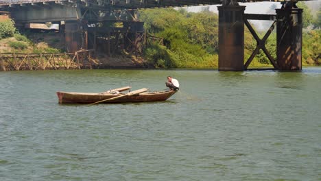 A-fisherman-struggles-to-pull-in-his-net-while-fishing-along-the-Nile-River