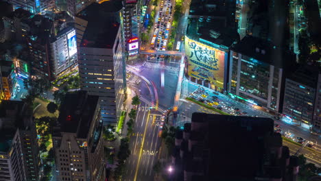 Timelapse-of-Night-Traffic-on-Crossroad-in-Colorful-Taipei-Taiwan-Downtown,-Birdseye-View