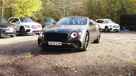 Bentley-Continental-GT-car-in-a-car-dealership-parking-lot-on-a-sunny-morning---Push-in-wide-shot