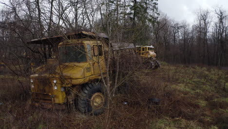 Drone-shot-of-decaying-old-industrial-trucks-that-have-been-abandoned