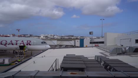 Qatar---Loading-Of-Cargoes-To-Qatar-Airplane-In-The-Airport-Before-Its-Flight-On-A-Sunny-Weather---Wide-Shot