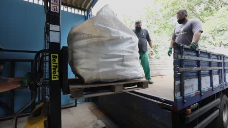 A-large-bag-of-used-computer-components-being-loaded-on-a-truck-to-take-to-a-recycle-center