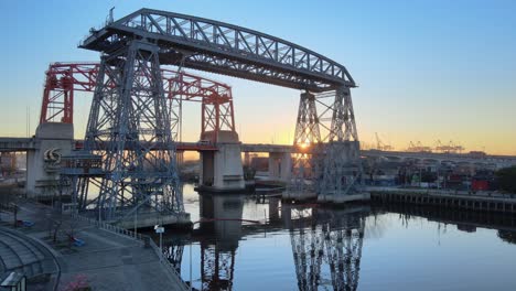 Static-view-of-Puente-Transbordador-and-river-at-sunrise,-Buenos-Aires