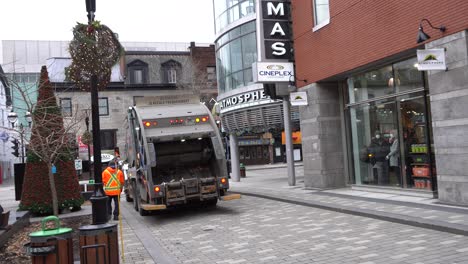 You-can-see-a-garbage-worker-moving-and-walking-near-the-truck