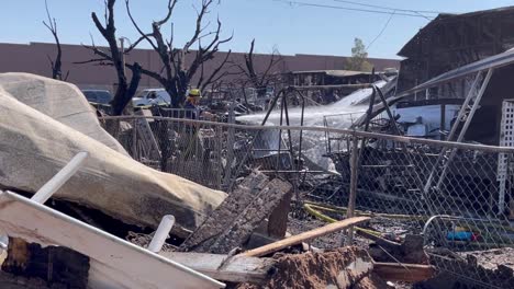 Fire-fighters-dowse-home-with-foam-spray-to-prevent-flare-up