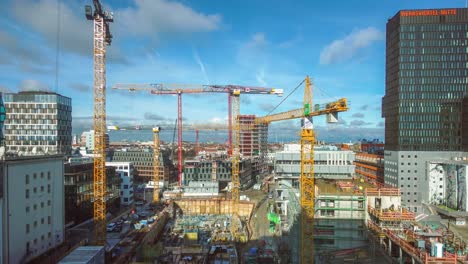 Construction-site-with-workers-and-cranes-in-Munich,-Germany-at-Werksviertel