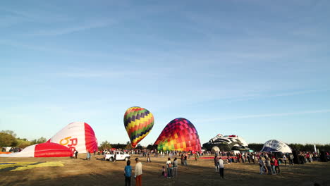 Novelty-Hot-air-Balloon-Resembling-Rider-On-Motorcycle-With-Typical-Hot-air-Balloons-At-International-Ballooning-Festival-In-Coruche,-Portugal