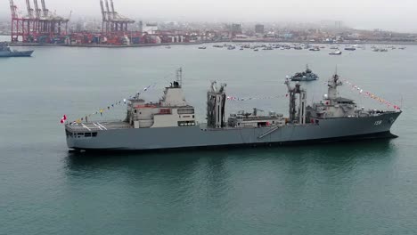 Peruvian-Navy-Ship-BAP-Tacna-With-Colorful-Flags-Anchored-Near-Callao-Container-Port-In-Lima,-Peru