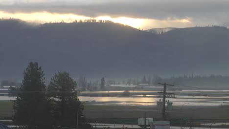 Establishing-shot-highlighting-the-vast-devastation-caused-to-farms-and-surrounding-areas-by-the-recent-floods-in-Abbotsford,-fields-completely-submerged-in-pools-of-water-in-British-Columbia,-Canada