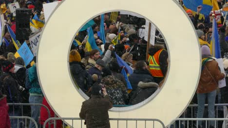 Crowd-show-anti-war-support-for-Ukraine-under-snowfall-light-Toronto