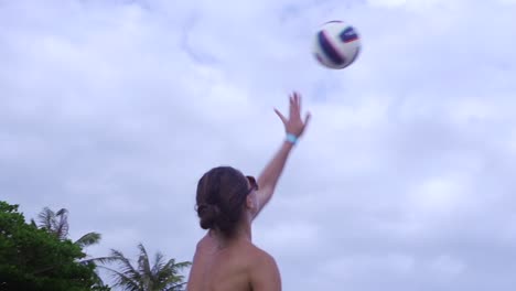 Mujer-Caucásica-Bronceada-Con-Bikini-Colorido-Golpea-Volley-Durante-La-Competencia-De-Voleibol-Unisex-En-La-Playa-Filmada-En-Cámara-Lenta-Desde-La-Parte-Trasera