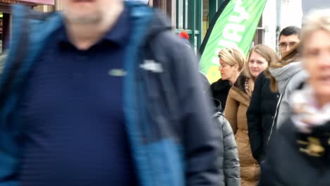 Casual-crowd-of-people-exploring-Manchester-city-streets-at-weekend