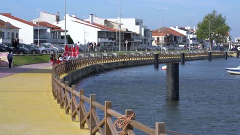 Menschen-Sitzen-An-Einem-Sonnigen,-Windigen-Tag-Im-Café-Von-Ria-De-Aveiro,-Torreira,-Portugal