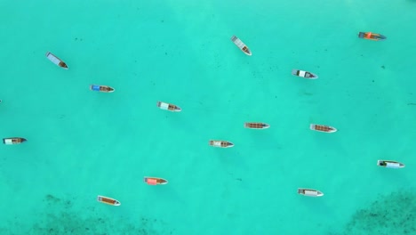 Nungwi-Beach,-Zanzibar---Tanzania---June-18,-2022---Boats-on-the-Indian-ocean-on-a-sunny-cloudy-day-during-sunrise