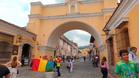 Shot-taken-while-walking-through-street-under-Santa-Catalina-Arch-in-Antigua,-Guatemala-at-daytime