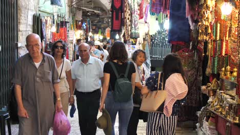 Tracking-brunette-female-tourist-on-the-street-of-old-town-in-Jerusalem,-Israel