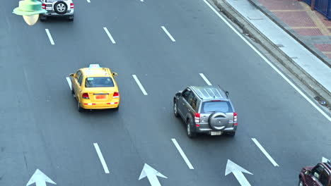 Cars-and-a-bus-passing-by-in-a-low-traffic-avenue-called-Avenida-Malecon-in-Guayaquil,-Ecuador