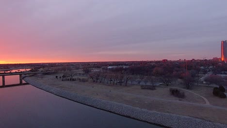 Revelación-Giratoria-De-Una-Puesta-De-Sol-Sobre-El-Río-Oklahoma-Con-El-Horizonte-De-La-Ciudad-De-Oklahoma