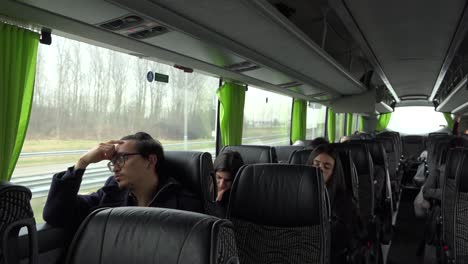 A-wide-shot-of-the-flixxbus,-with-all-kind-of-tired-passengers,-driving-in-the-early-morning