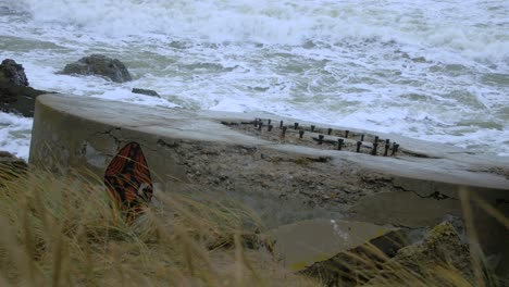 Big-waves-hitting-the-abandoned-concrete-coast-defense-building-ruins-in-stormy-weather