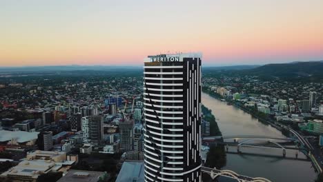 Orbiting-aerial-view-of-Meriton-hotel-at-sunrise