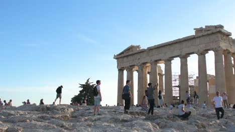 Tourists-enjoying-the-Parthenon-Temple-at-Acropolis-hill,-Athens,-Greece